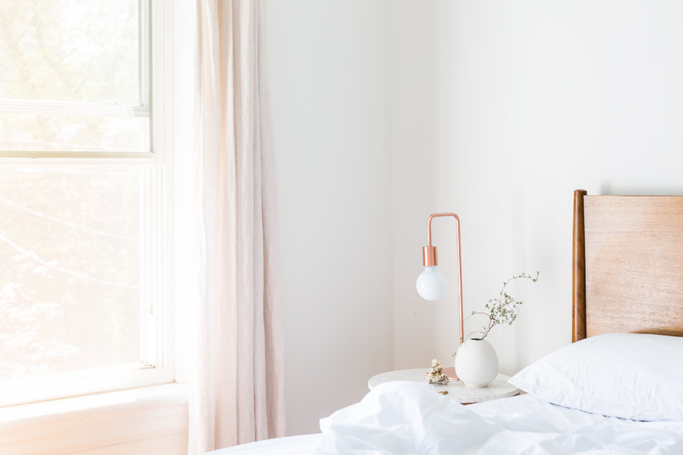 White bedroom with sheer blush curtains