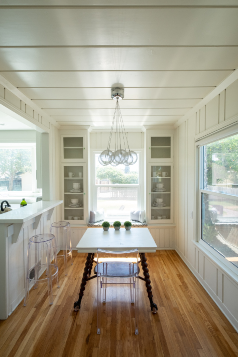 White kitchen with a dining nook by the window