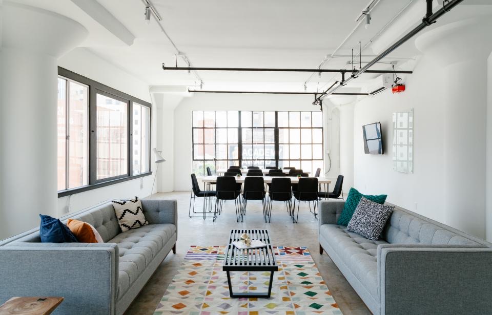 Wide open room with two sofas and a long table